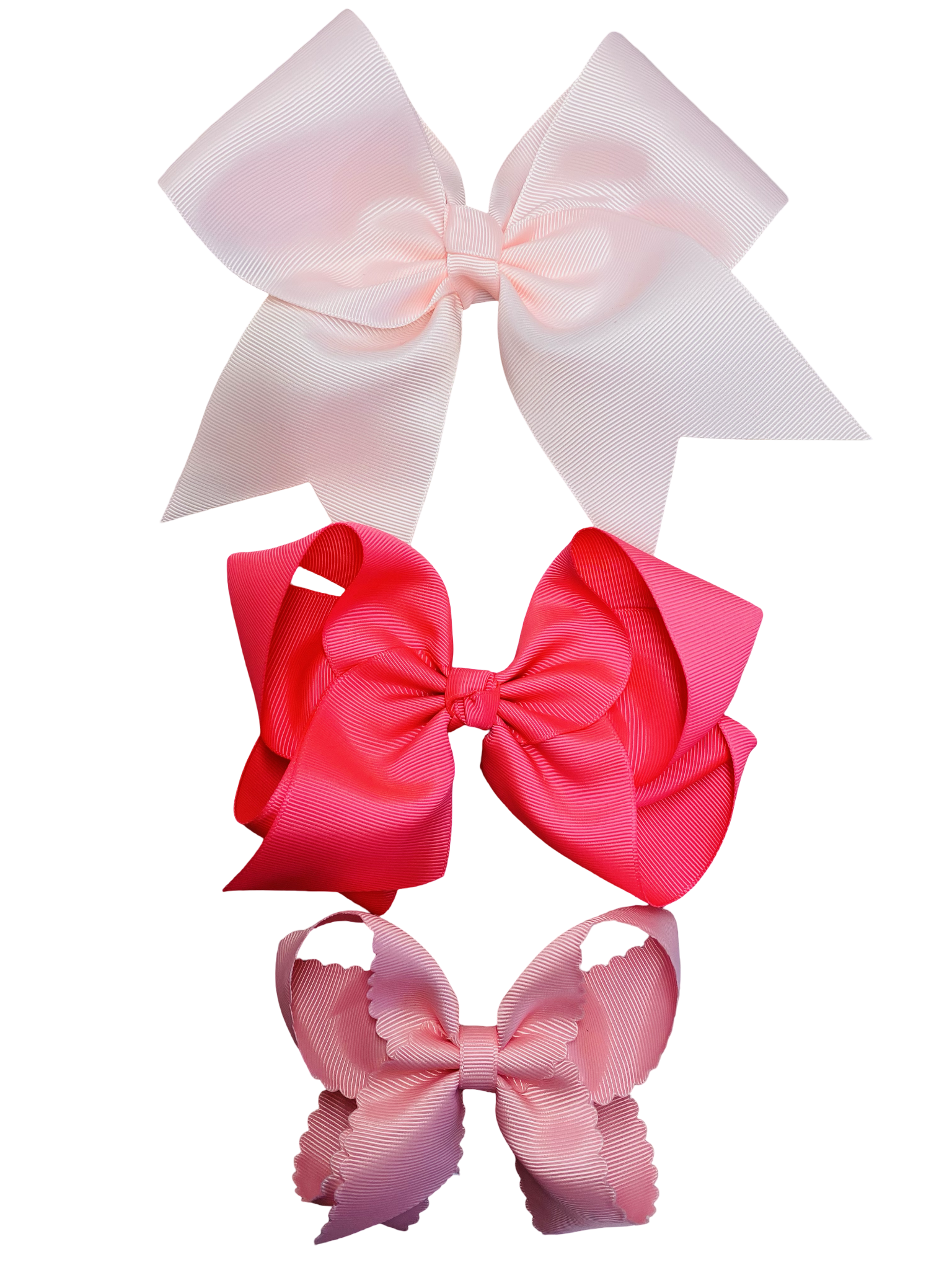 Three large hair bows in pinks on a white background