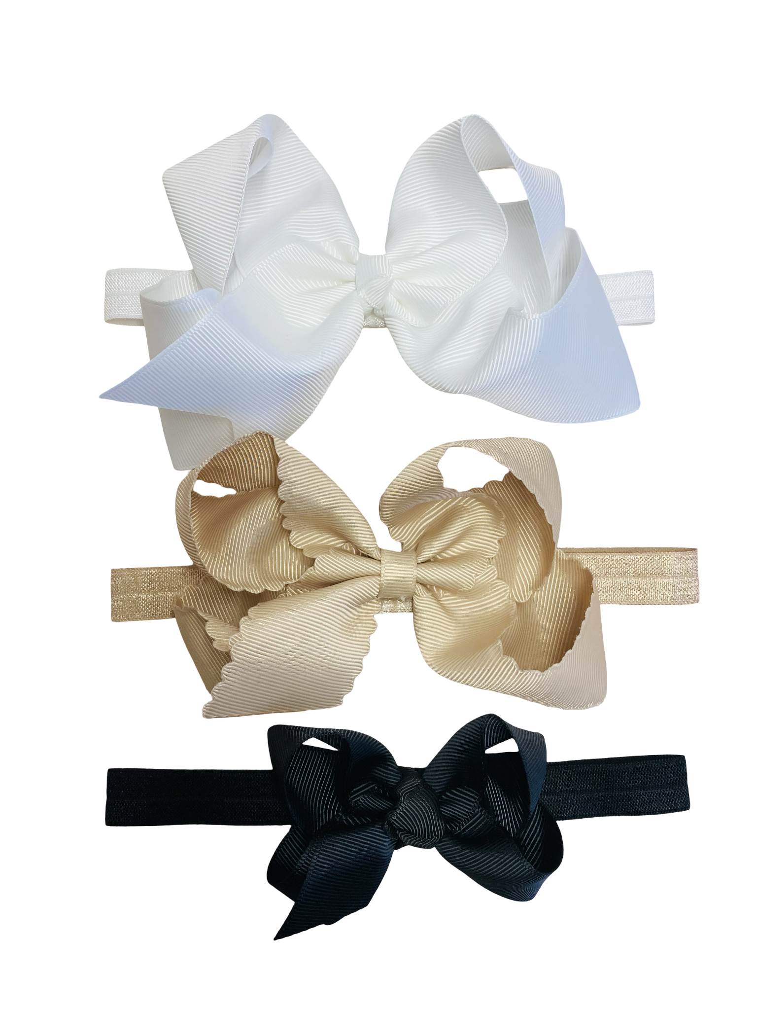 Three hair bows in white, beige, and black on a white background