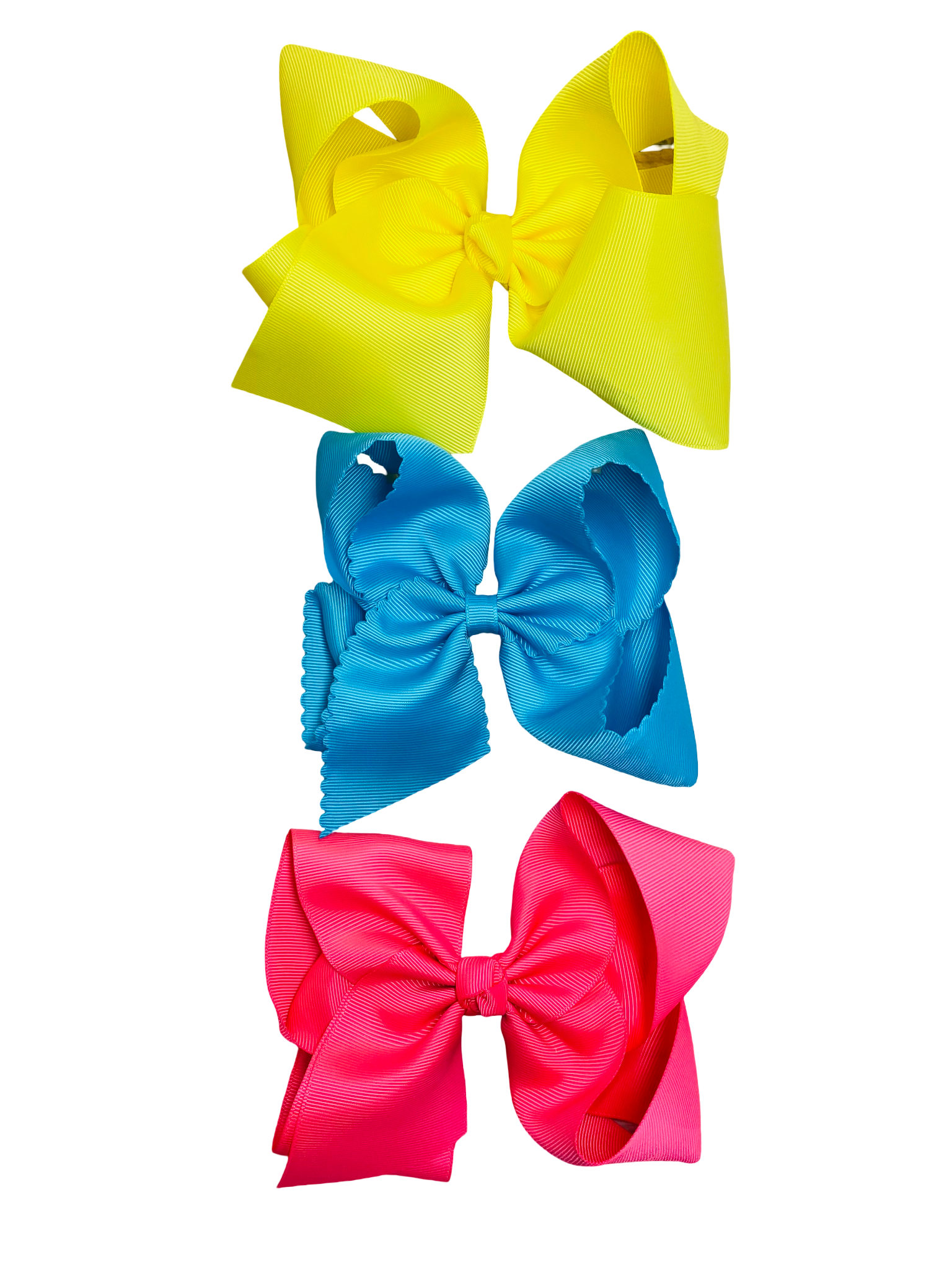 Three colorful hair bows (yellow, blue, pink) on a white background
