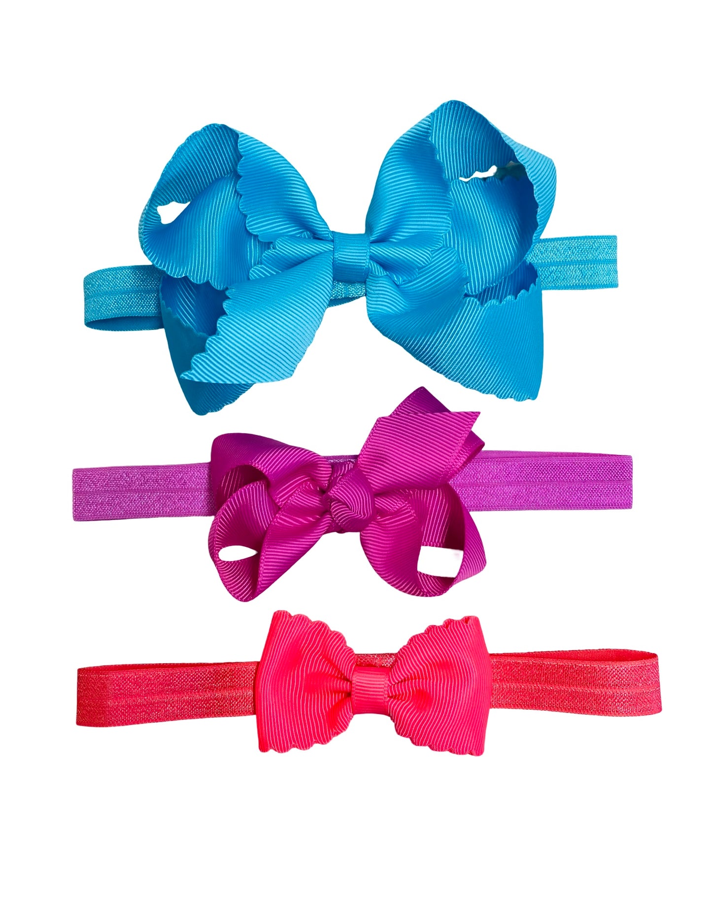 Three colorful hair bows in blue, pink, and red on a white background