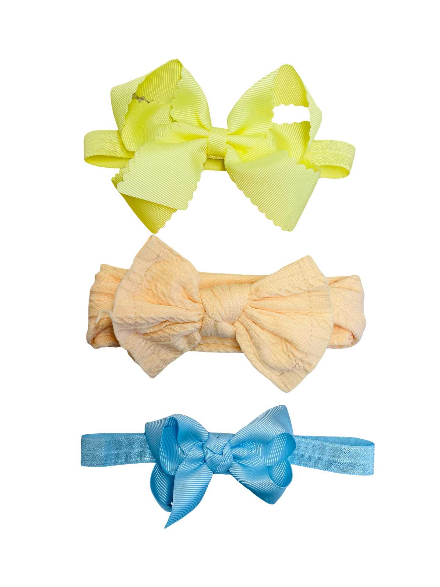 Three colorful hair bows on a white background