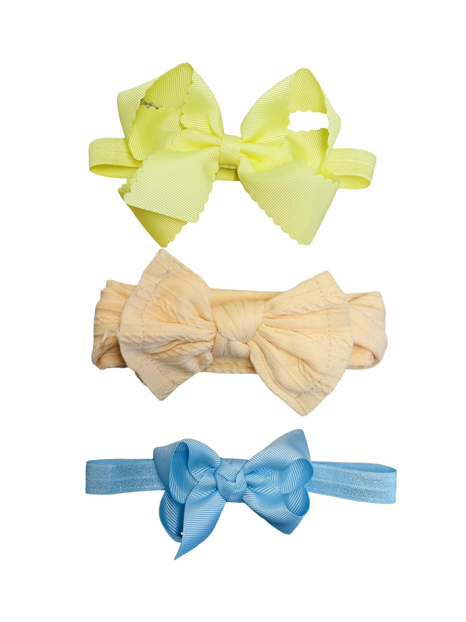 Three colorful hair bows on a white background