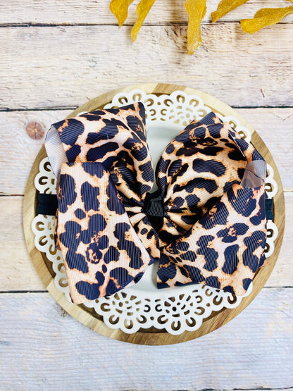 Leopard print headband on a decorative plate with a wooden background