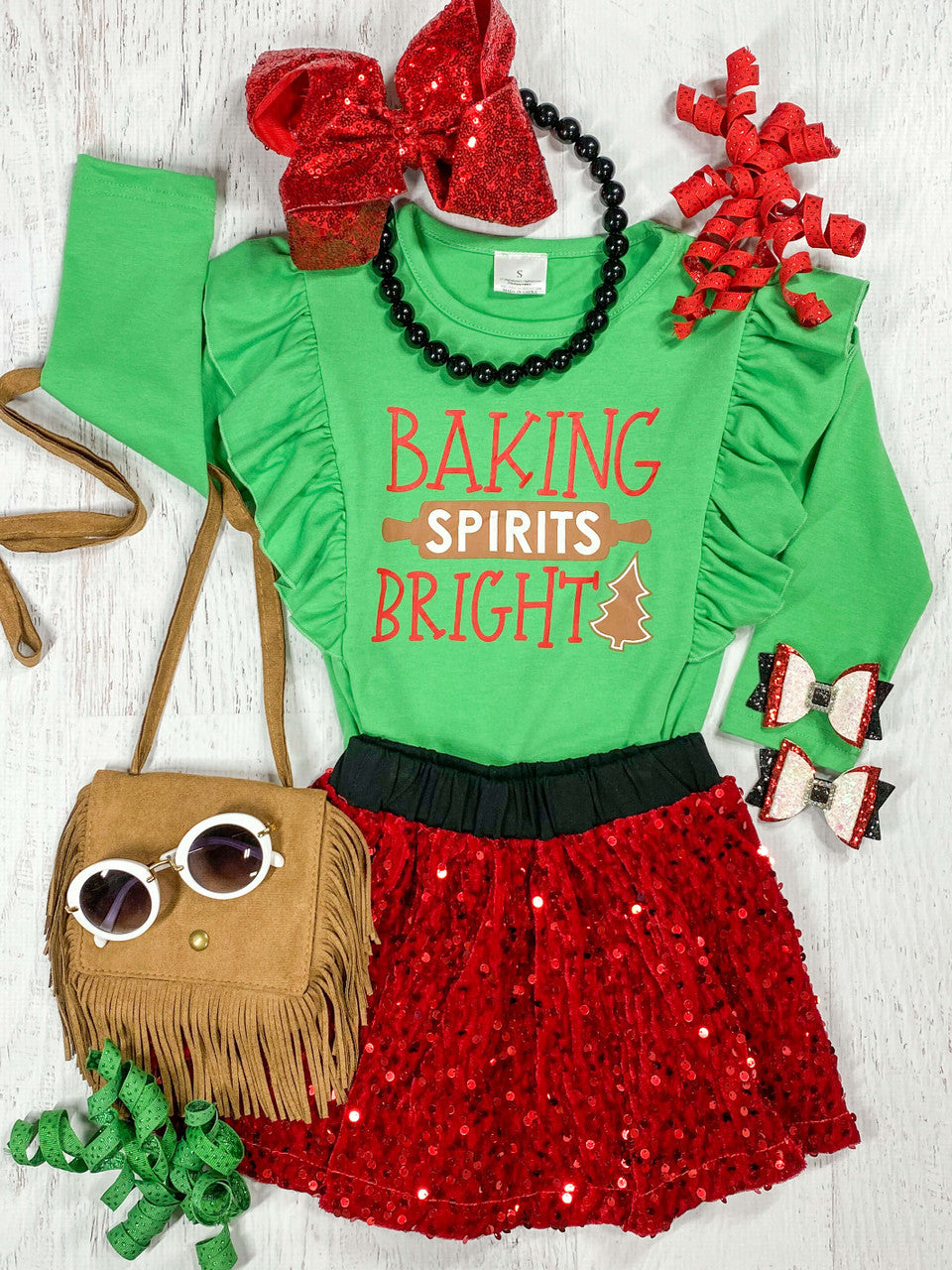Long sleeve green shirt that reads 'Baking Spirits Bright' with a red sequin skirt