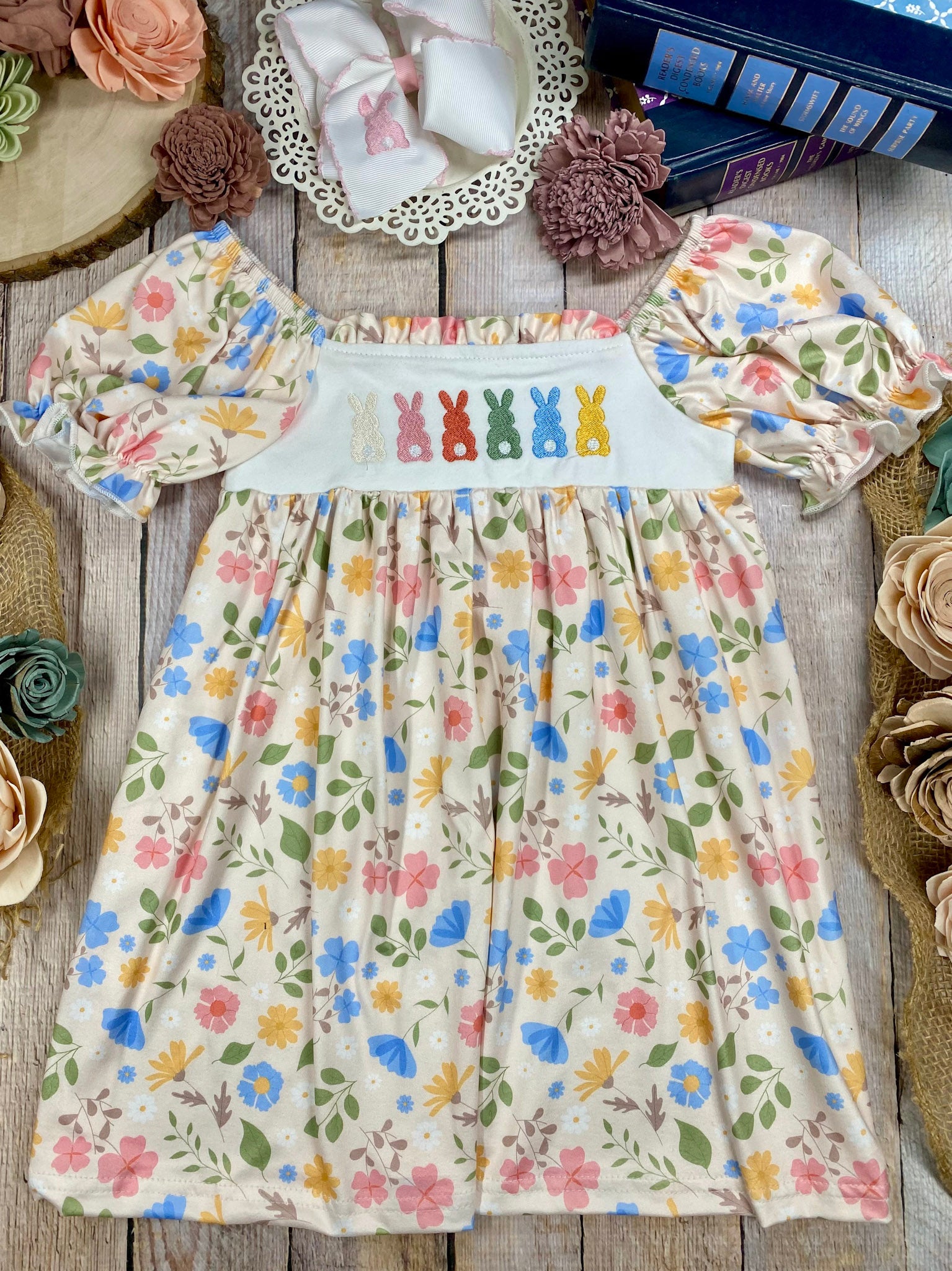 Floral dress with bunny design on a wooden surface