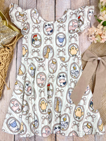 Boutique Girls Farm Animal Dress on a wooden background