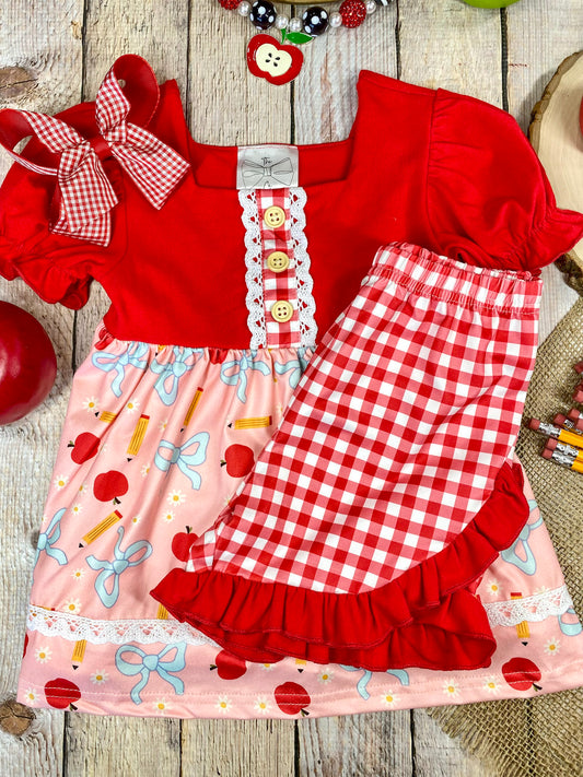 Red and pink children's outfit with checkered shorts on a wooden background - Alternative view