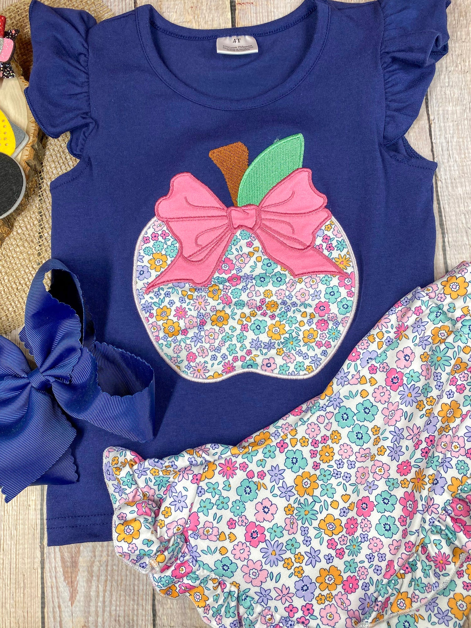 Girls back to school two-piece with floral apple appliqué ruffle tee and coordinating ditsy floral ruffle shorts