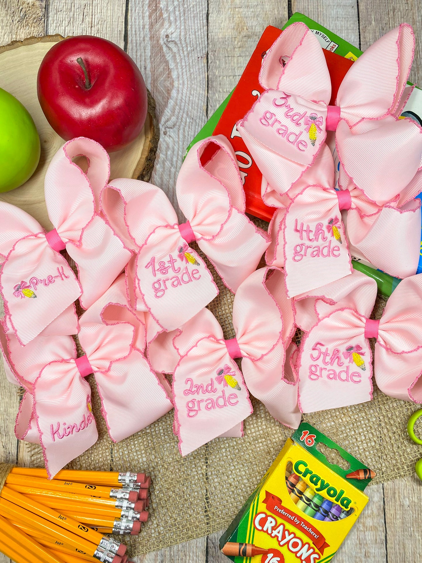 Pink School Grade Embroidered Cheer Bow on a wooden background