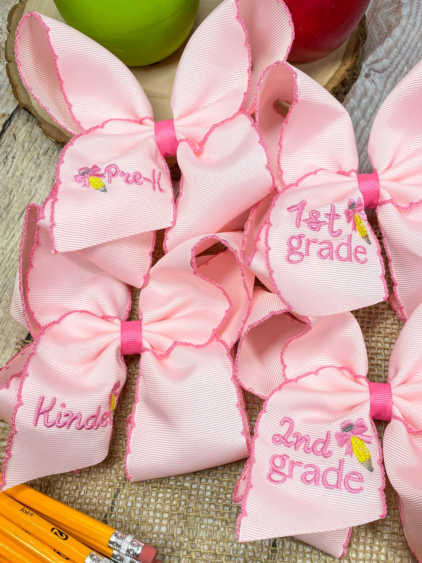 Pink School Grade Embroidered Cheer Bow on a wooden background