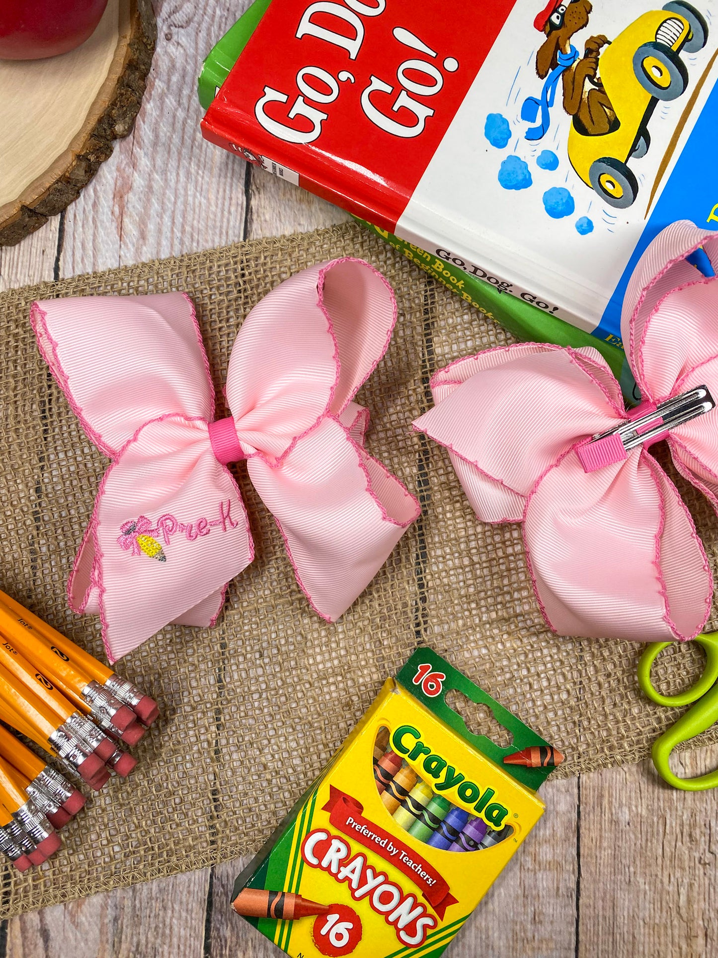 Pink School Grade Embroidered Cheer Bow on a wooden background
