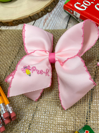 Pink School Grade Embroidered Cheer Bow on a wooden background