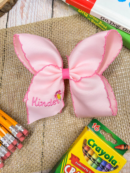 Pink School Grade Embroidered Cheer Bow on a wooden background