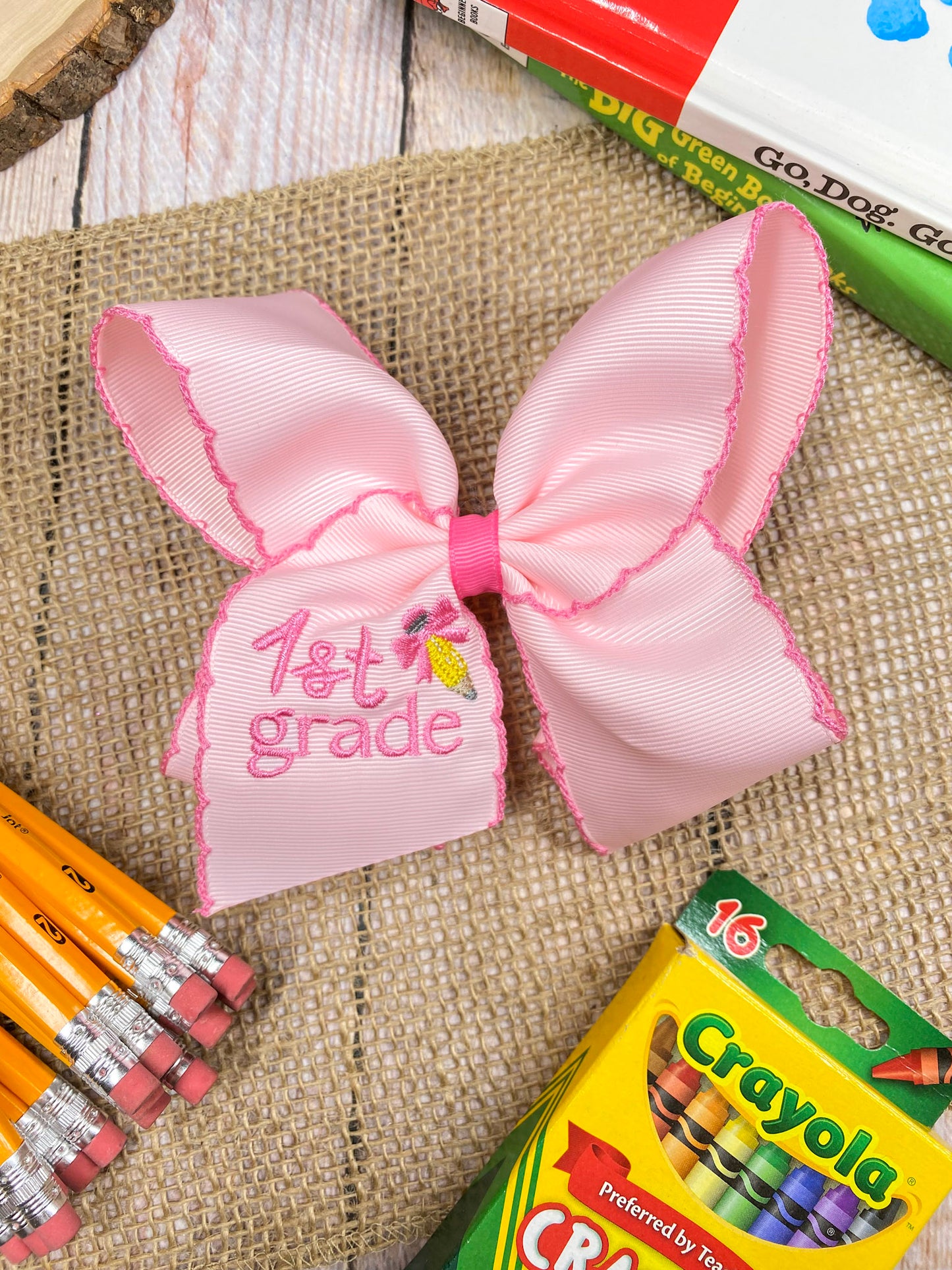 Pink School Grade Embroidered Cheer Bow on a wooden background