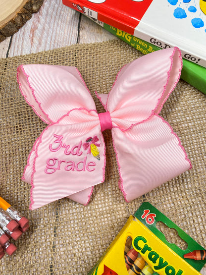 Pink School Grade Embroidered Cheer Bow on a wooden background