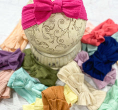 Cable knit bow headbands in a variety of colors