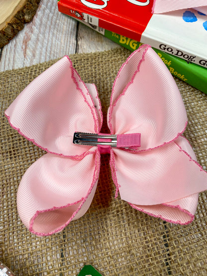 Pink School Grade Embroidered Cheer Bow on a wooden background