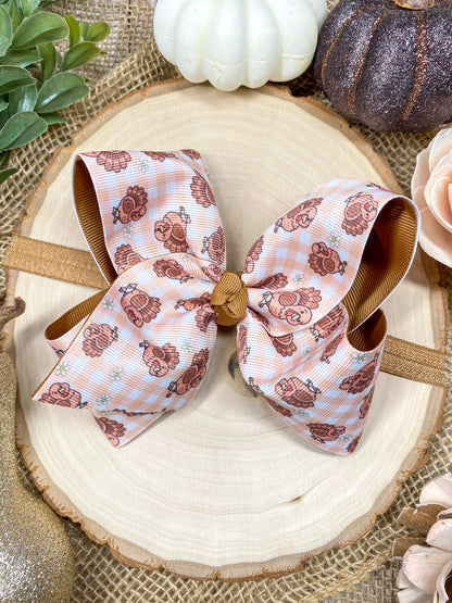Turkey Print Hair Bow on a wooden background