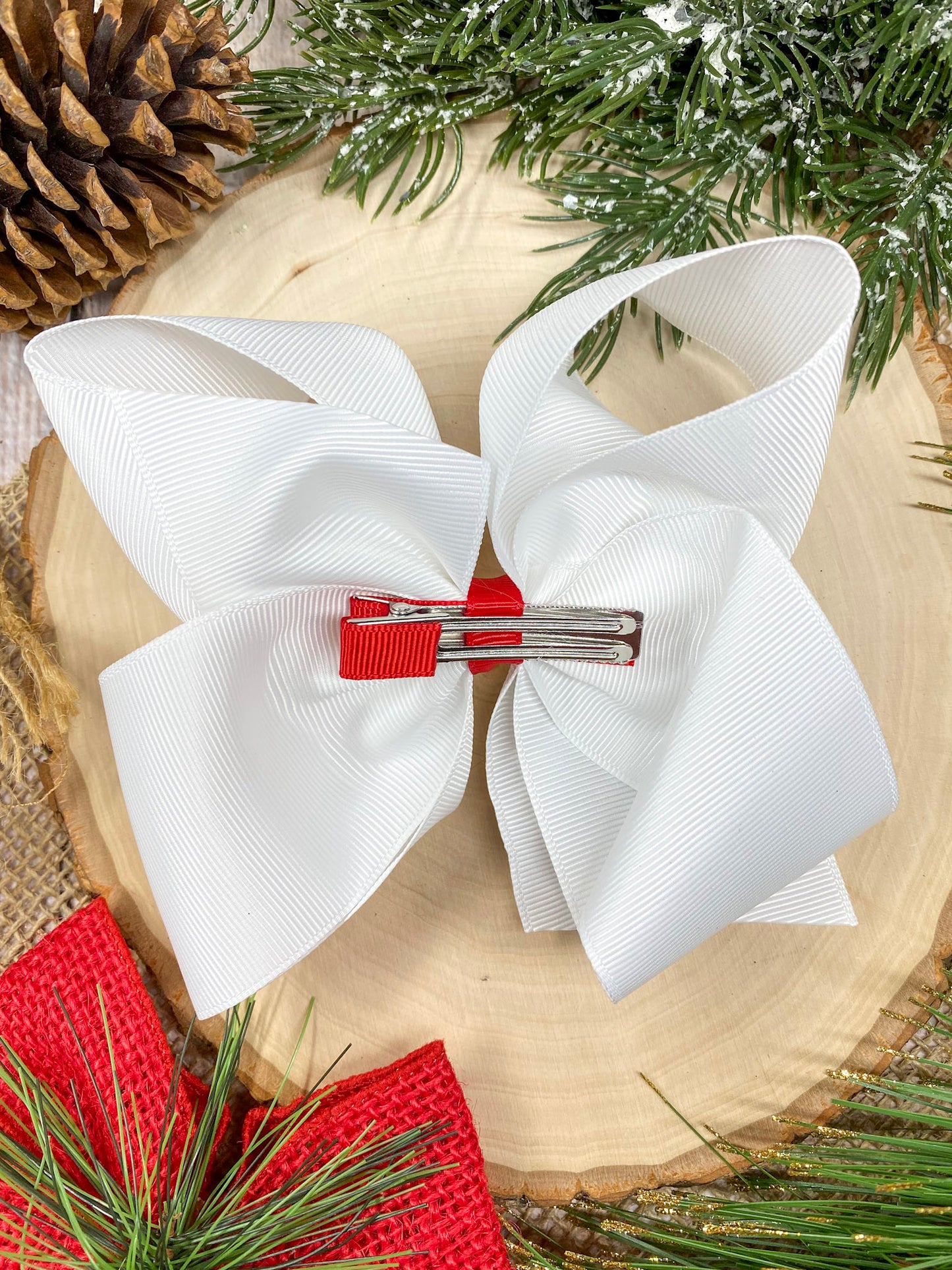 Wreath Embroidered Hair Bow on a wooden background