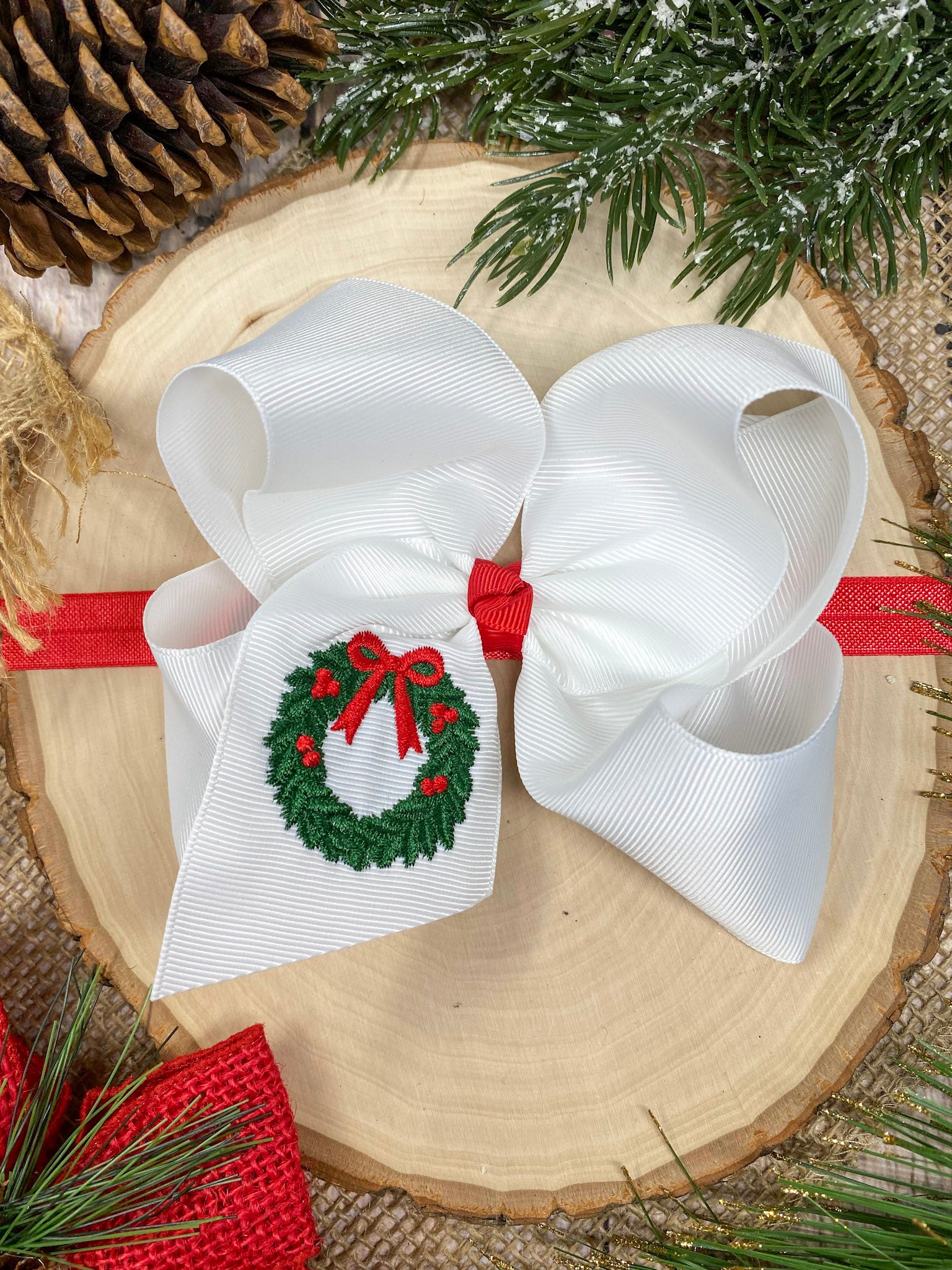Wreath Embroidered Hair Headband on a wooden background