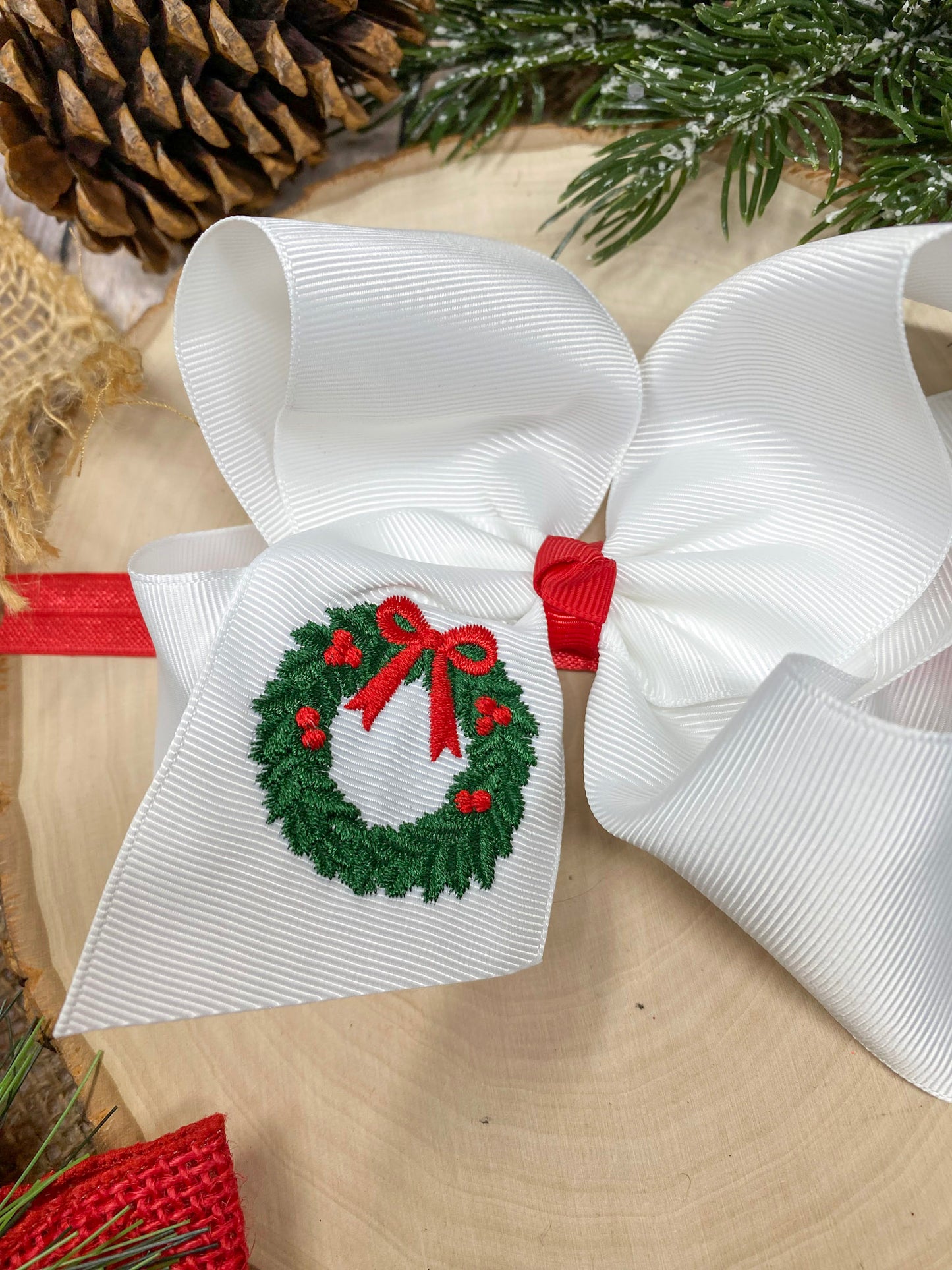 Wreath Embroidered Hair Headband on a wooden background