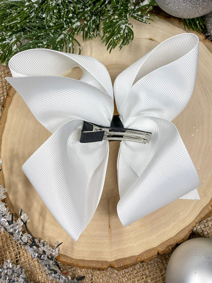 White Snowman Embroidered Bow on a wooden background