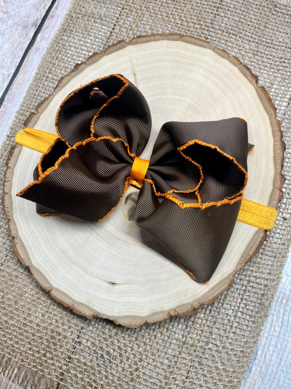 chocolate bow with orange trim on orange headband