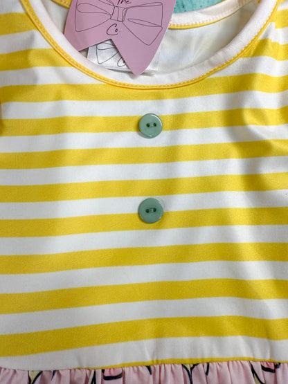close up photo showing the buttons and yellow stripes on top of the dress