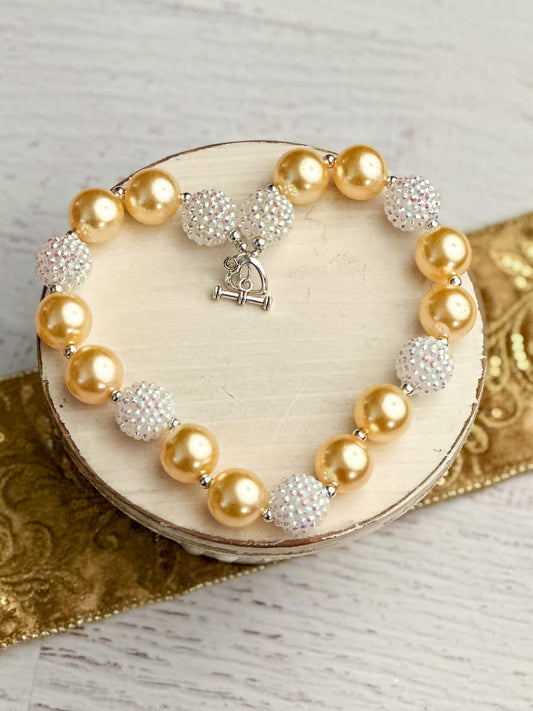 Gold and white rhinestone chunky bead necklace, measures approximately 17" with toggle closure.