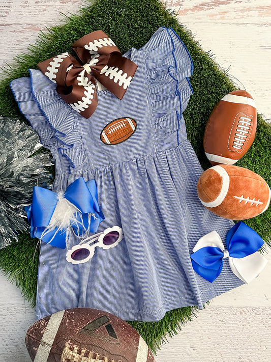 blue gingham dress with ruffled sleeves and a football 