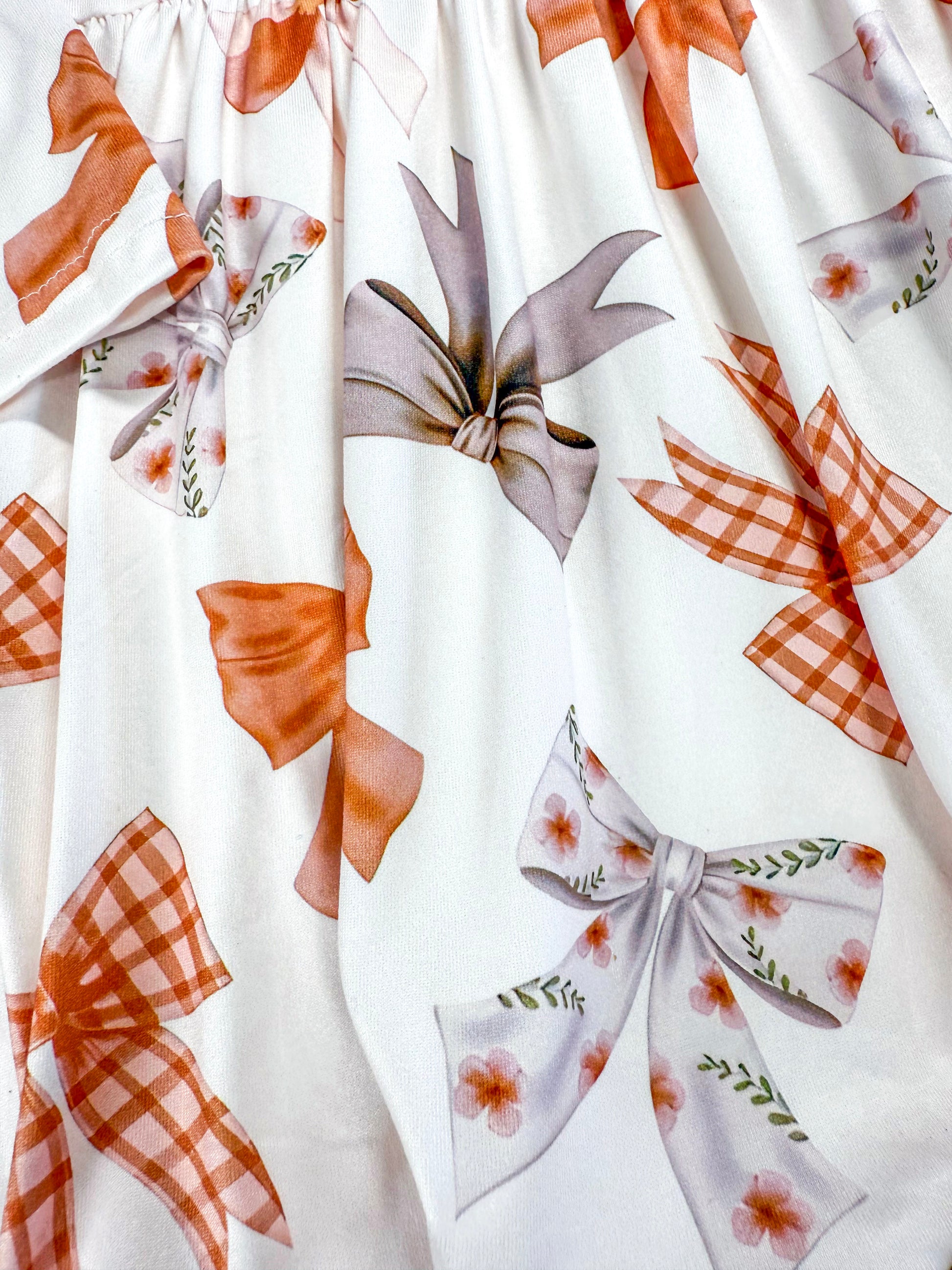 close up pf the bow pattern on dress