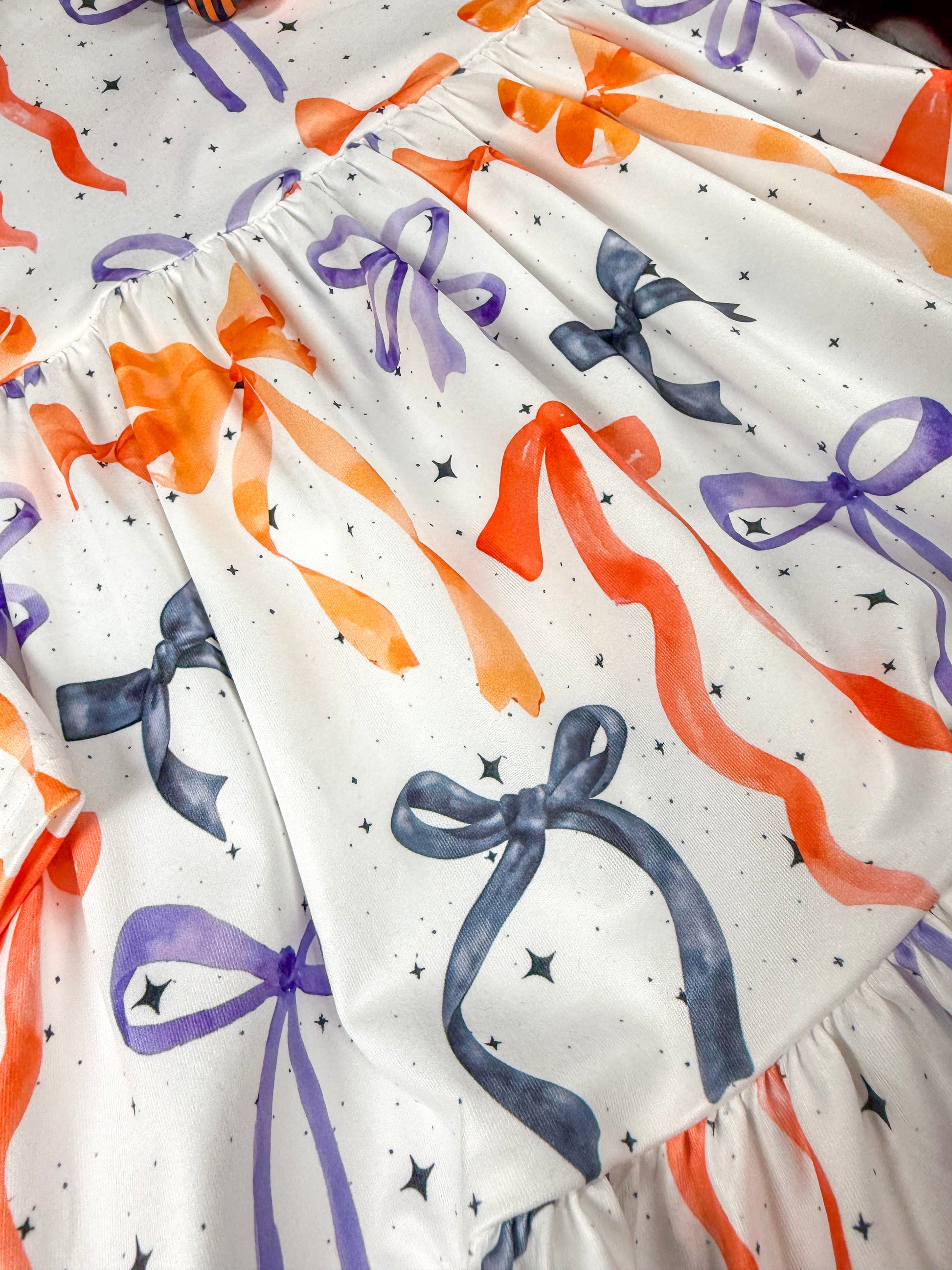 close up of bow pattern printed on dress