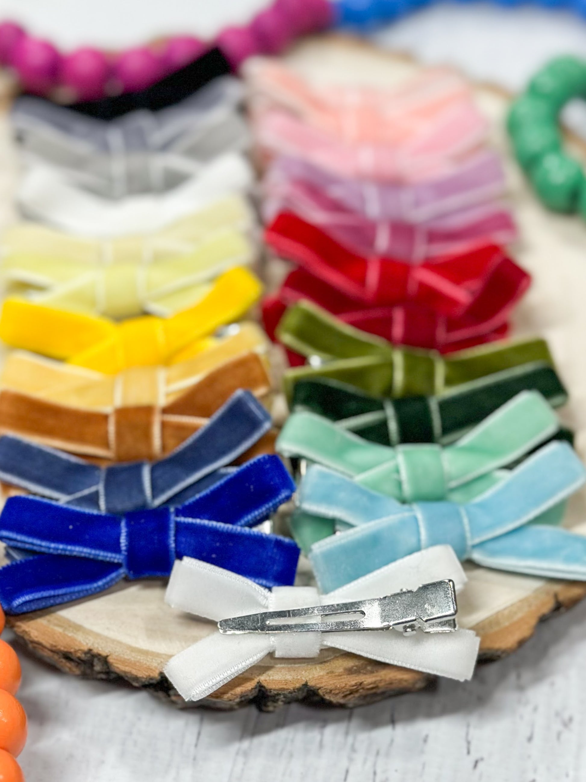assortment of velvet bow clippies in multiple colors showing the back clip