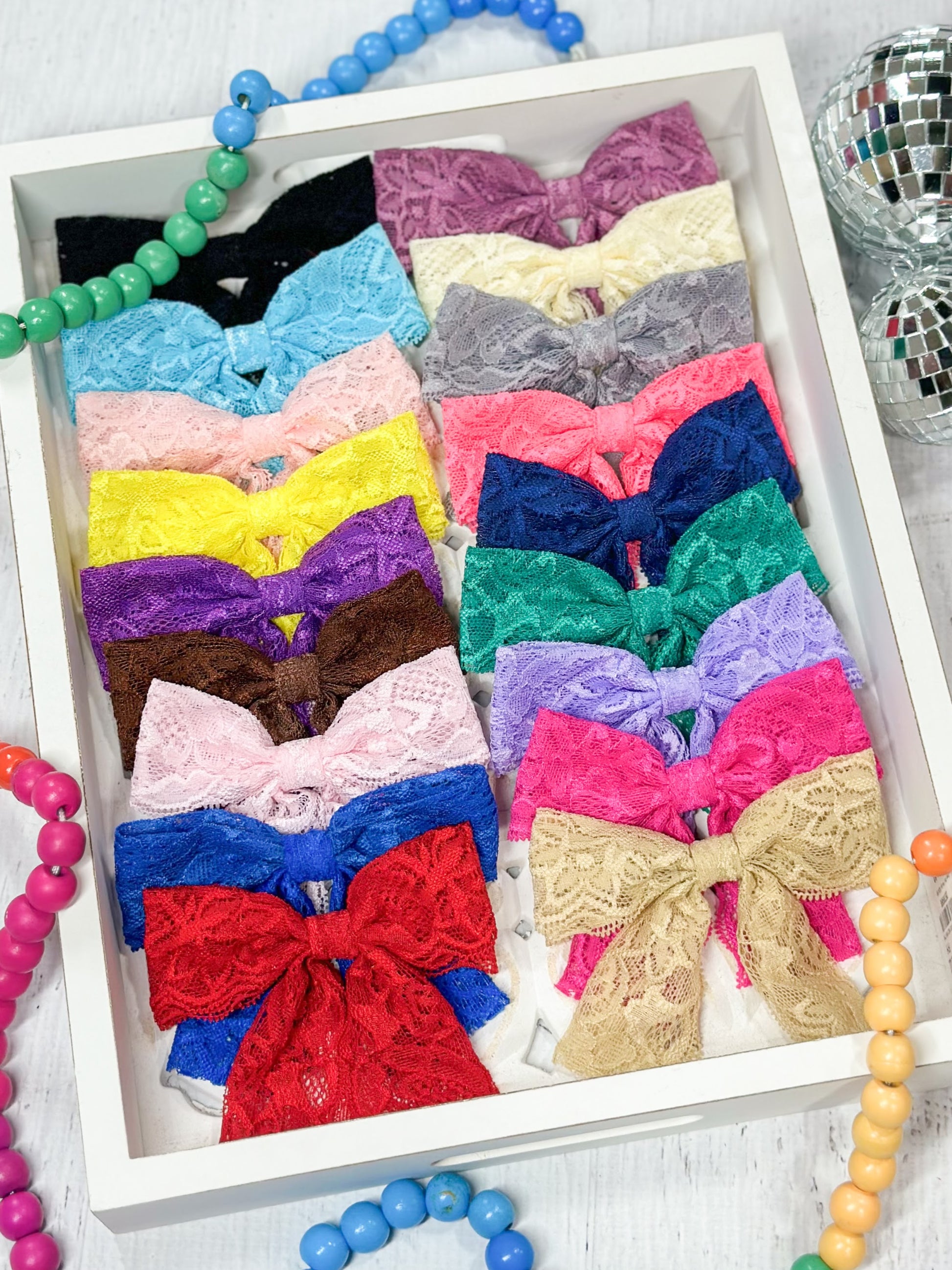 assortment of lace hair bows in multiple colors