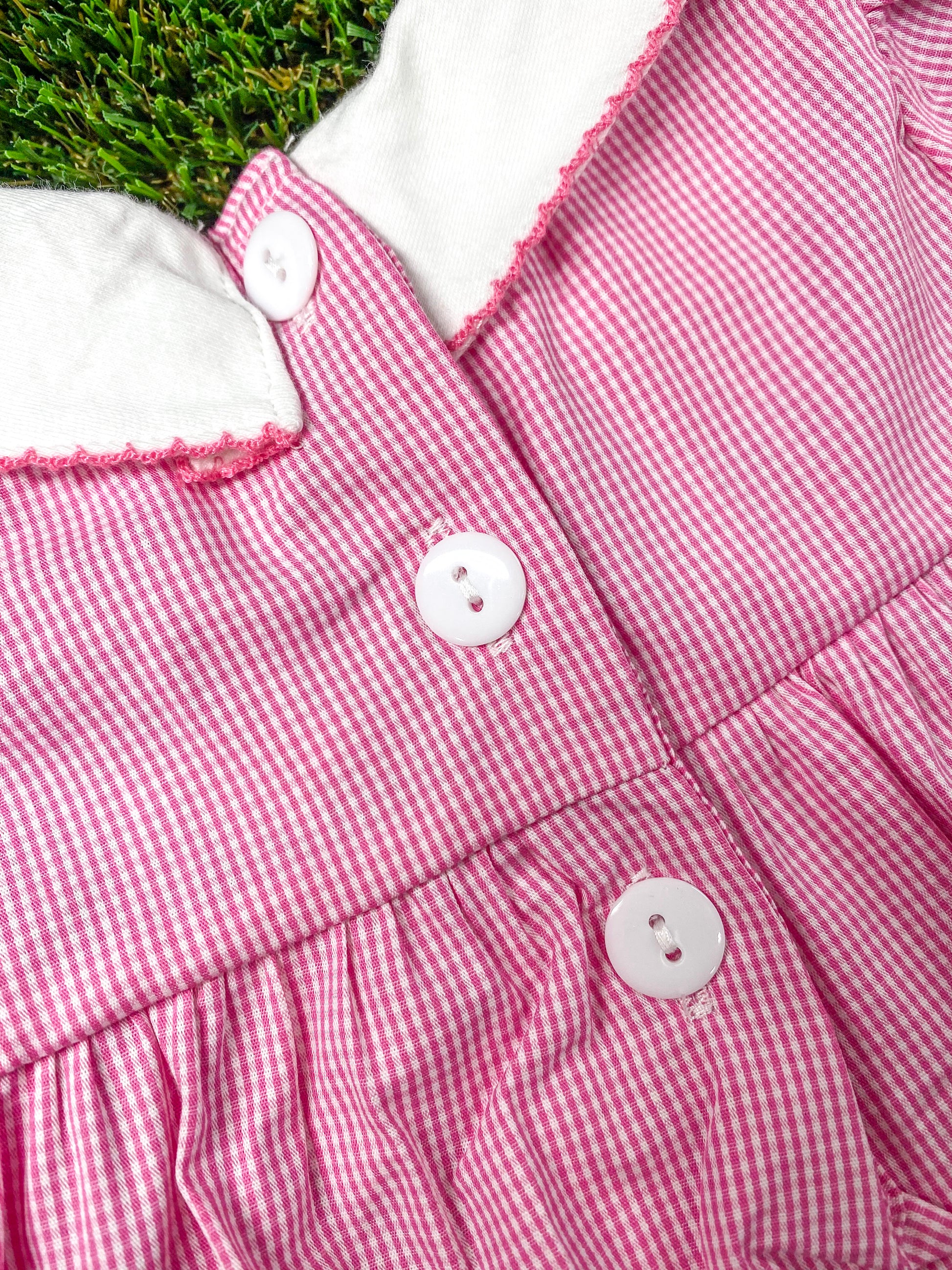 close up of the buttons on back of the onesie