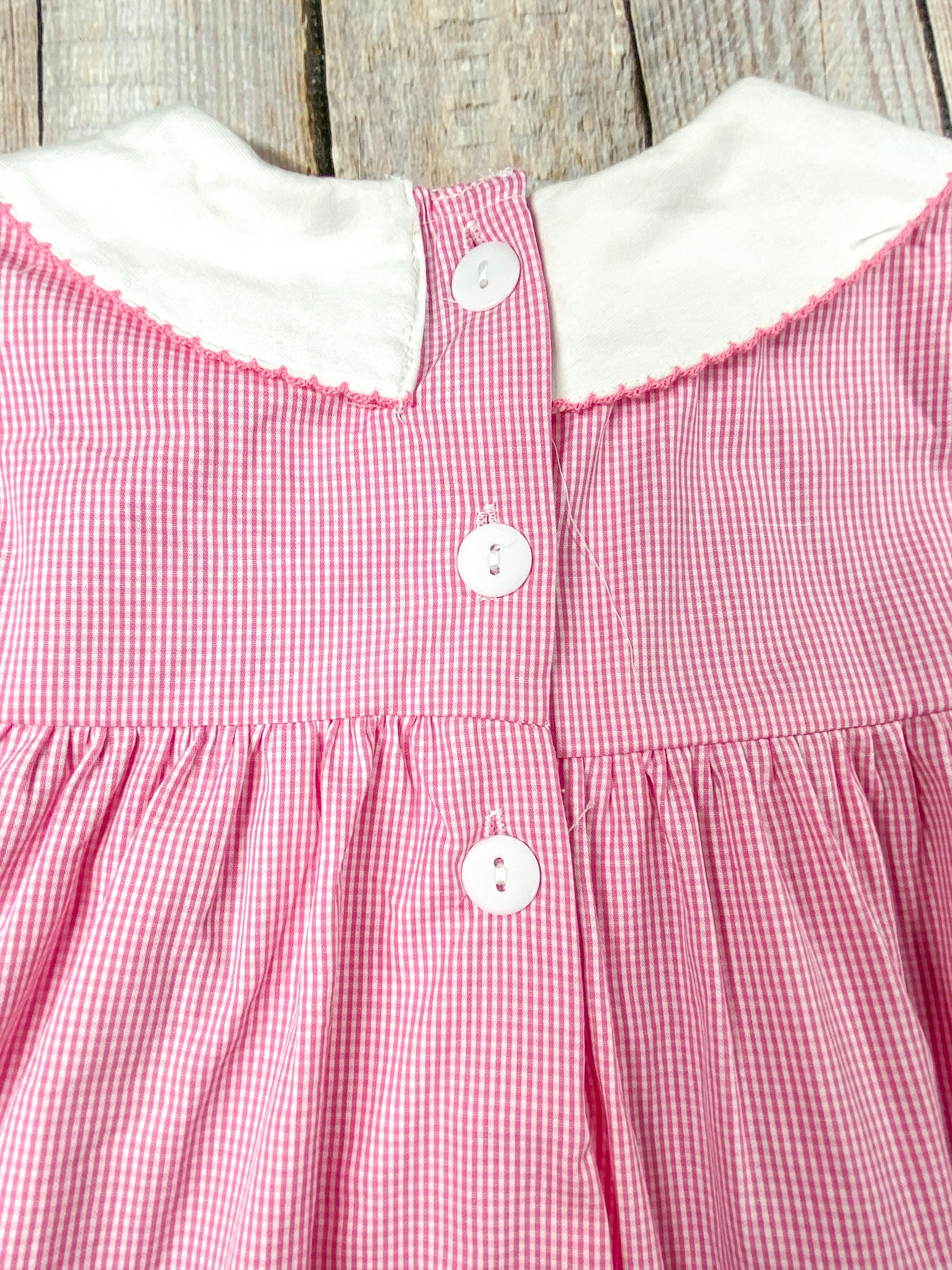 back of the dress showing 3 buttons starting from the collar and coming down