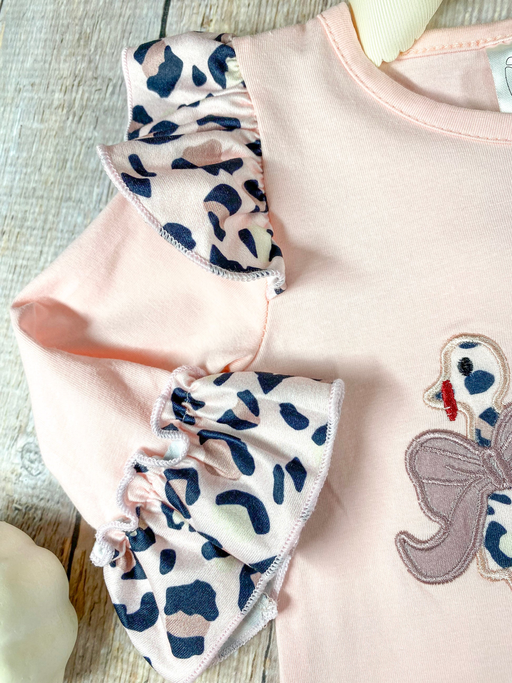 close up of the animal print ruffle at top of sleeve/shoulder