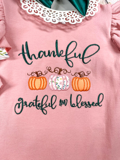 close up of the embroidery on front saying "thankfuk grateful and blessed" in cursive and 3 pumpkins