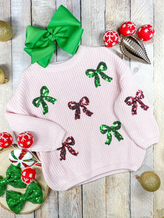 light pink sweater with red and green coquette bows made of sequins 