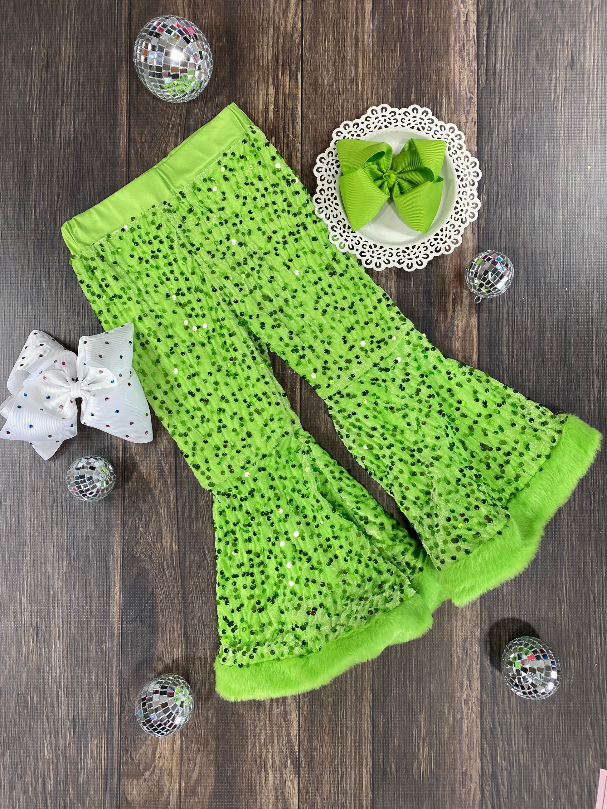 lime green sequin pants on wooden background