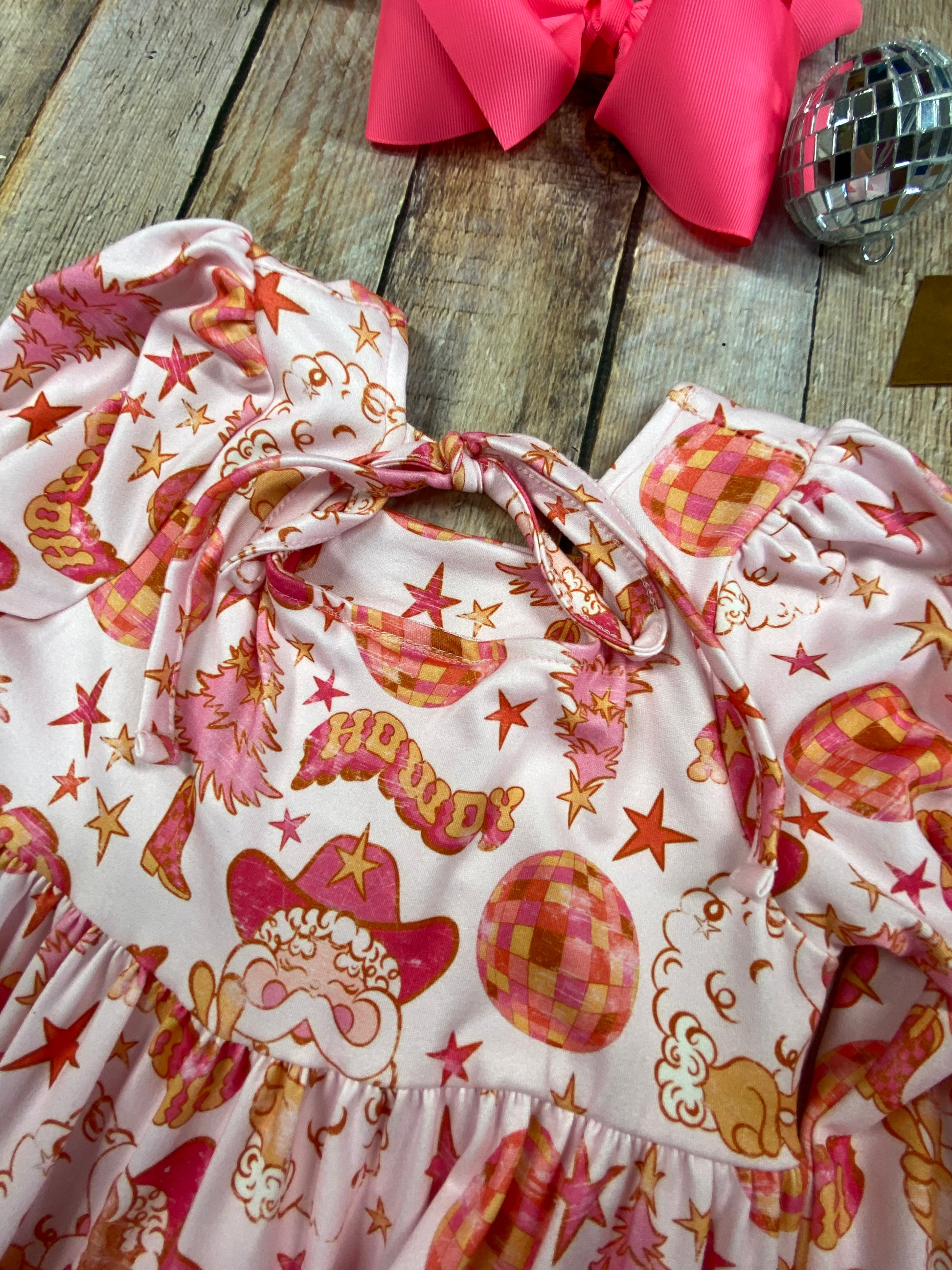 Back of Western Pink Santa twirl dress with retro holiday print