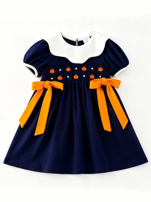 Girls navy smocked pumpkin dress with white collar and orange waist bows