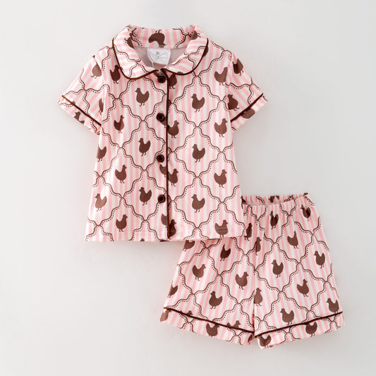 Pink pajama set with chicken pattern on a light gray background