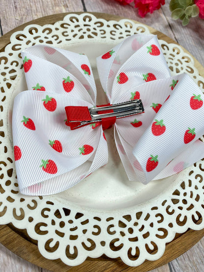 White bow with strawberry pattern on a decorative plate