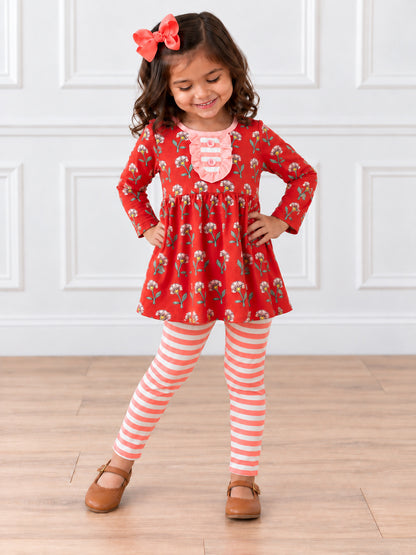 model wearing Floral tunic with pink striped leggings