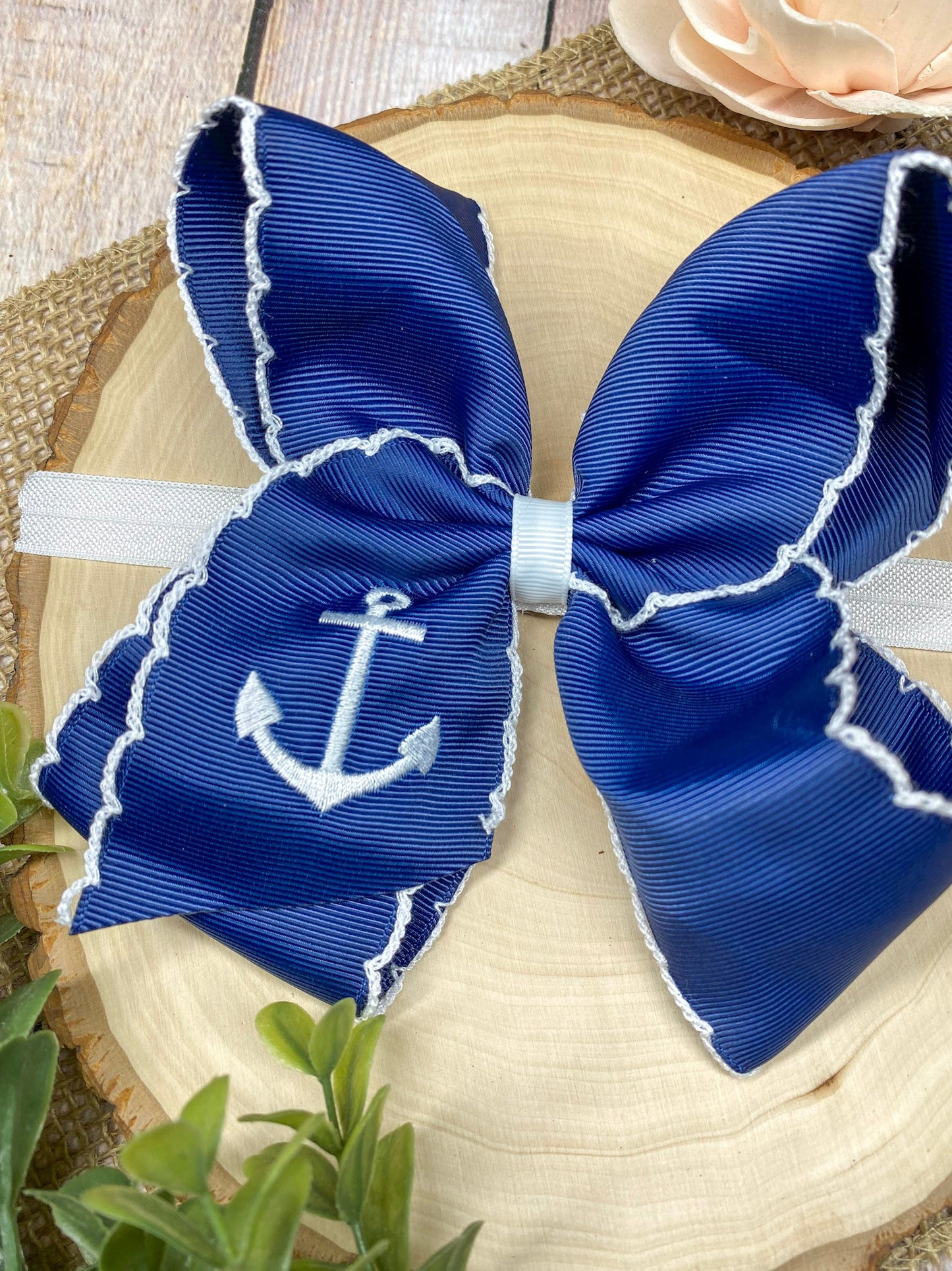 Anchors Away Embroidered Moonstitch Headband on a wooden background