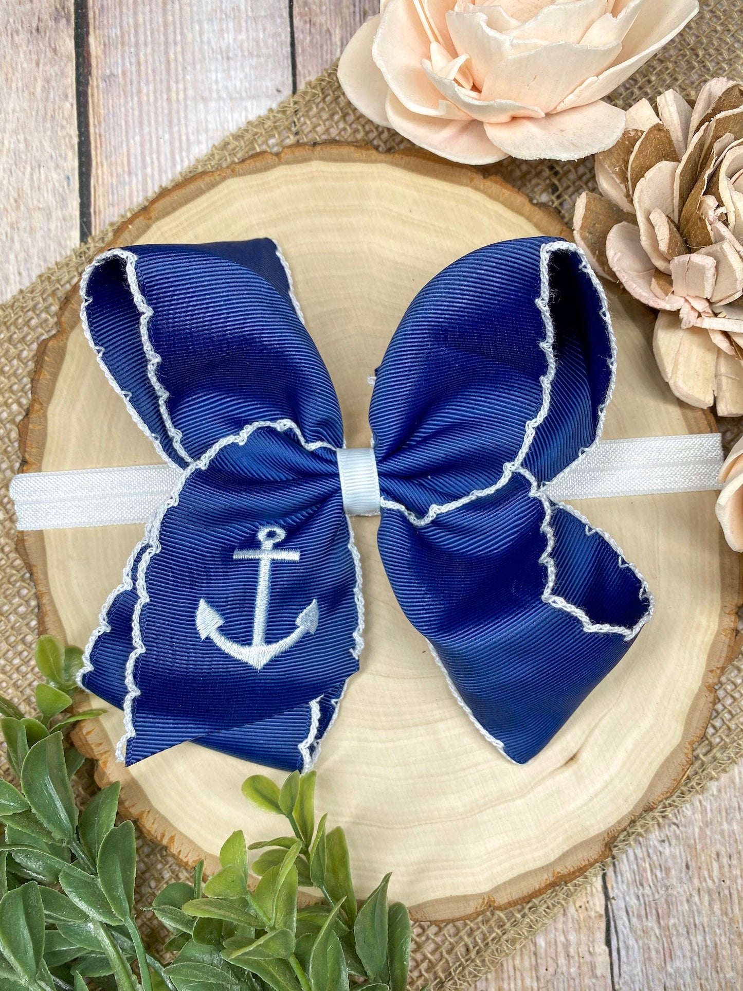 Anchors Away Embroidered Moonstitch Headband on a wooden background