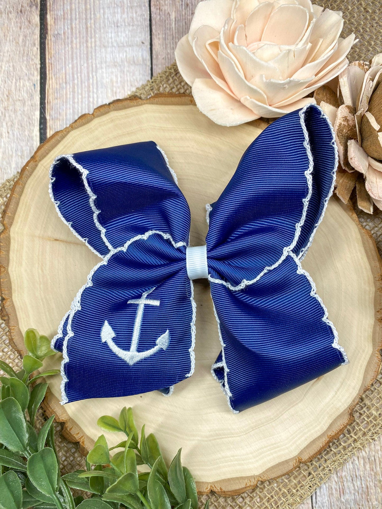 Anchors Away Embroidered Moonstitch Hair Bow on a wooden background