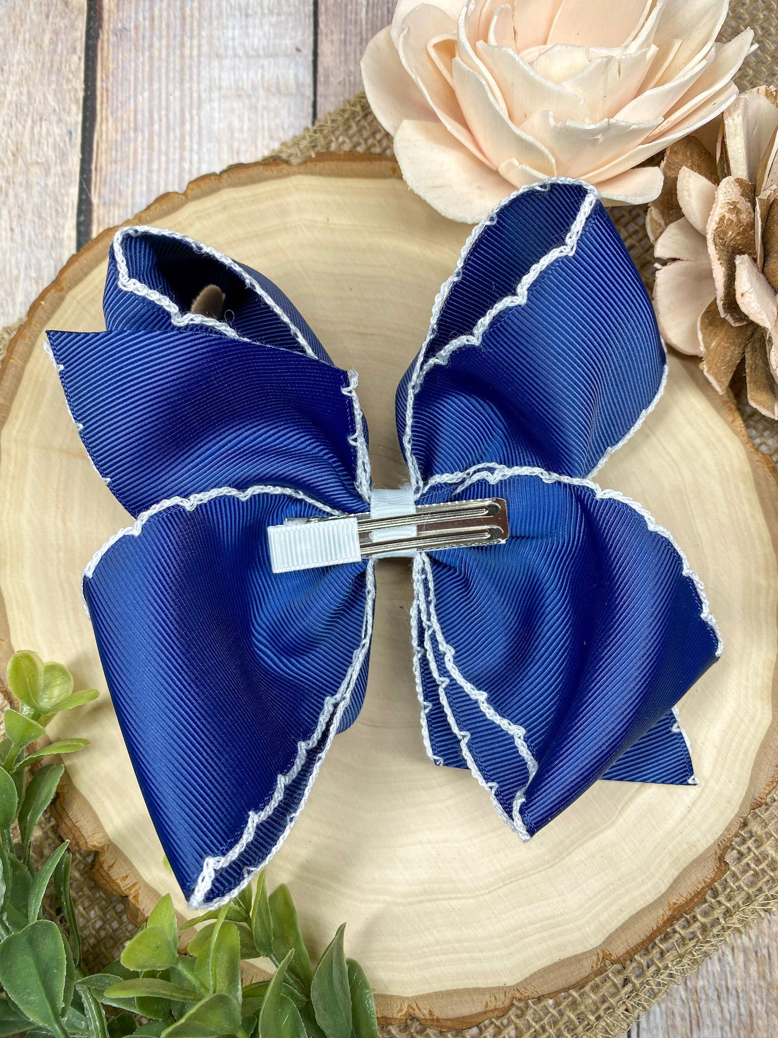 Anchors Away Embroidered Moonstitch Hair Bow on a wooden background