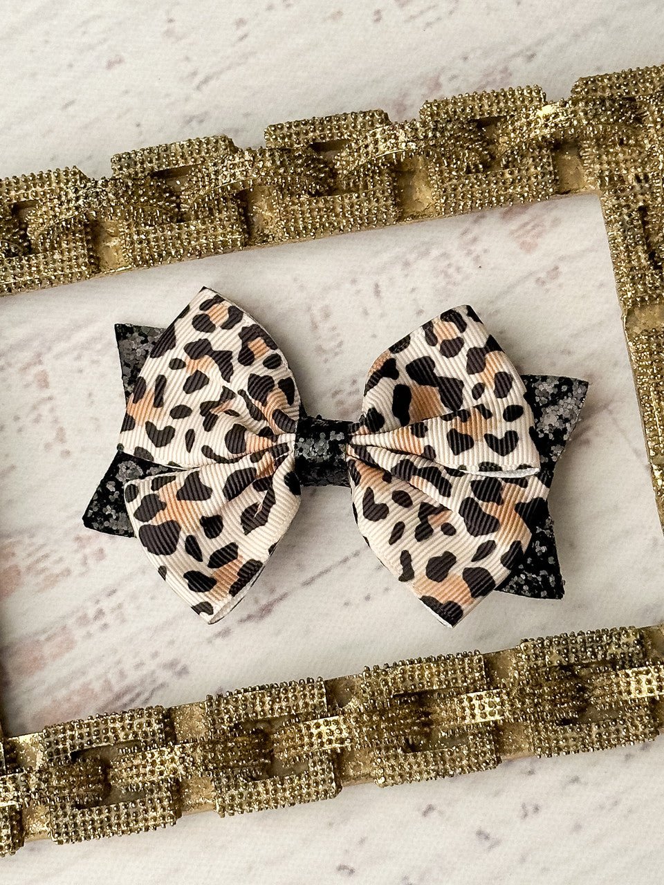 Animal print and black glitter hair bow on single alligator clip